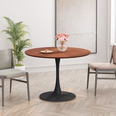 a dining room table with two chairs and a vase on the table next to it