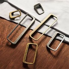 three metal objects sitting on top of a wooden table