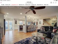 a living room filled with furniture and a ceiling fan