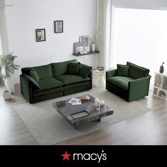 a living room with green couches and white walls