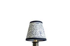 a table lamp with a blue and white shade on the top, against a white background