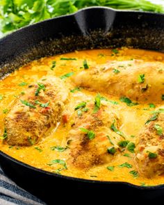 a skillet filled with meat covered in sauce and garnished with parsley