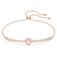 a pink heart bracelet with white pearls on the side and a rose cut diamond in the middle