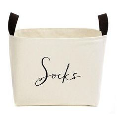 a white storage bag with black handles and the word sox written on it in cursive writing