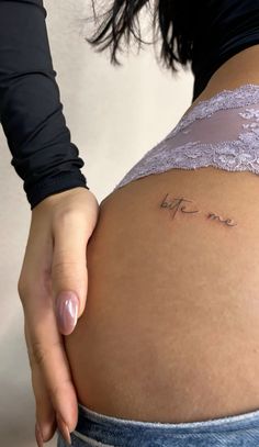 a woman's stomach with the word love written on it, and her name is in cursive writing