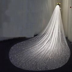 a white wedding dress with sequins on it