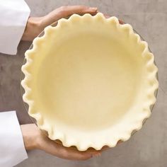 a person holding a pie pan in their hands