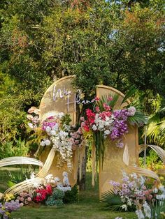 an outdoor wedding setup with flowers and greenery