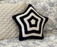 Introducing our Crocheted Star Pillow Pattern, perfect for adding a touch of whimsy to any living space. This pattern is designed for intermediate crocheters and includes easy-to-follow instructions for creating a plush star-shaped pillow. The pattern uses soft, durable yarn and a combination of basic crochet stitches to bring the design to life. Whether you're looking to cozy up your favorite reading nook or add a playful accent to a child's bedroom, this Crocheted Star Pillow Pattern is sure t Goth Crochet Pillow, Star Pillow Pattern, Crochet Starburst, Yarn Pillow, Black White Bedroom, Crocheted Star, Cushion Crochet, Black White Bedrooms, Spiral Crochet