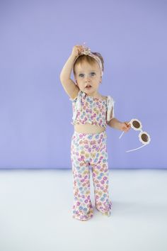 Bask in summer's warmth with our Ray of Sunshine Dream Smocked Flare Set. Made from bamboo material, this smocked flare set is not only comfortable, but also environmentally friendly. With a playful sunglasses print, this outfit is perfect for girls to rock in the summer or spring. Made from theÂ softest and most breathable seasonal bamboo viscose material, your babe won't want to take this off! Designed for all the loveÂ and extra play!Â Our Ray Of Sunshine, Sunglasses Print, Tuxedo Accessories, Toddler Flower Girls, Girls Gloves, Girls Dress Outfits, Toddler Flower Girl Dresses, Infant Flower Girl Dress