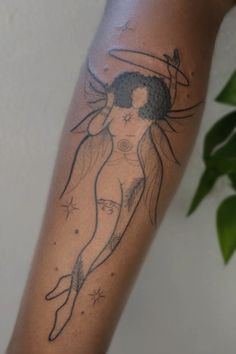 a woman's arm with a tattoo on it that has a star and moon above her head