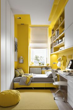 a bedroom with yellow and gray walls, white furniture and bookshelves on the shelves