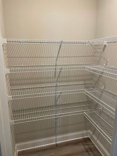 an empty closet with wire shelves in it