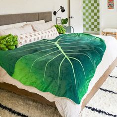 a bed with green leaves on it and the price is $ 489 00 for the comforter