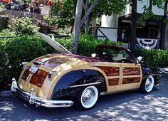 an old fashioned car parked in front of a house