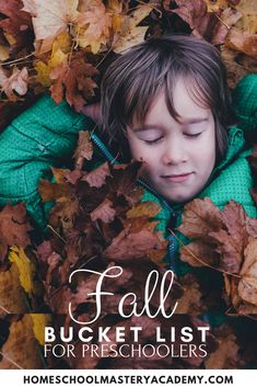 a young boy laying in leaves with the words fall bucket list for preschoolers