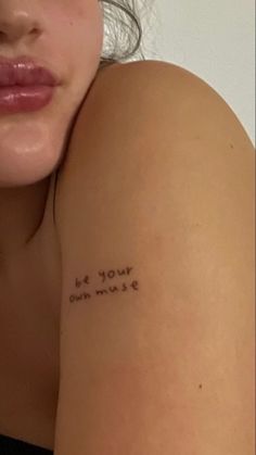 a woman with a tattoo on her arm saying be your own music