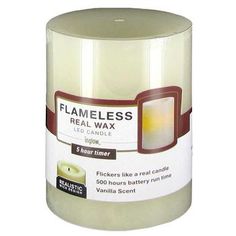 a candle that is sitting on top of a white tablecloth with the label flameless real wax