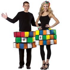 a man and woman standing next to each other with rubik cubes on their backs