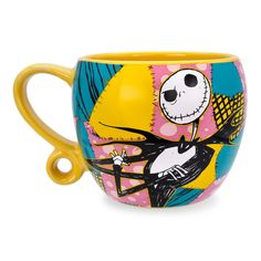 a coffee cup with a cartoon character painted on the side and handles in different colors