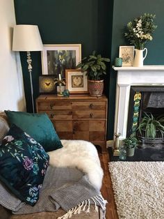 a living room filled with furniture and a fire place next to a white rug on top of a hard wood floor