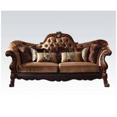 an ornately decorated couch with pillows on it's back and armrests