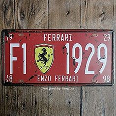 a red ferrari license plate mounted to a wooden wall