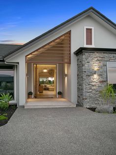 the front entrance to a modern home at dusk