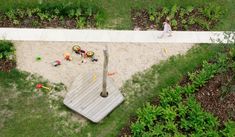 an aerial view of a child's play area in the middle of a garden