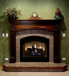 a fireplace in a living room with green walls