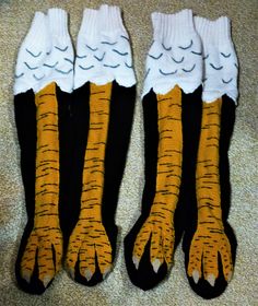 two pairs of black and yellow socks with claws on them