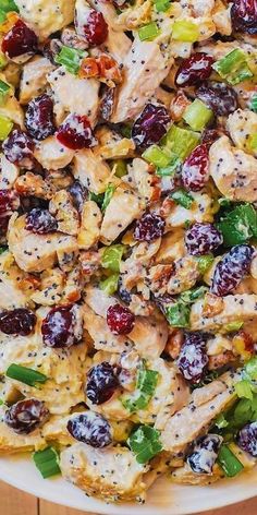 a white plate topped with chicken and cranberry salad