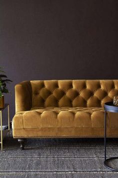 a living room with a couch, table and potted plant on the side tables