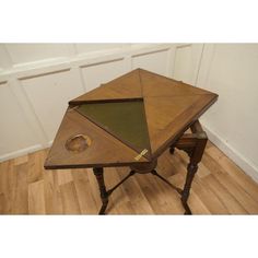 an old wooden table with a hole in the middle