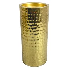 a gold colored metal vase with holes in it