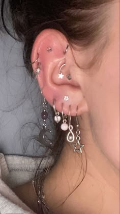 a woman with piercings on her ear and nose