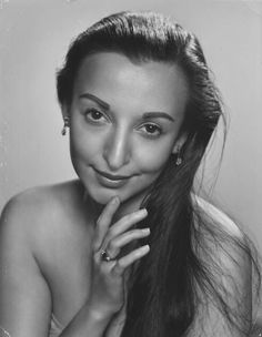 black and white photograph of a woman with long hair wearing an elegant ring on her finger