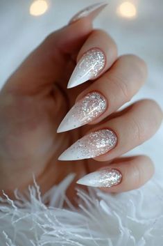 Glitter French Tips Almond Nails, White Glitter Ombre Nails Almond, White Glitter Fade Nails, Glittery Winter Nails, White Sparkle Christmas Nails, White Sparkly Christmas Nails, Stiletto Holiday Nails, White Nails With Designs Almond, Winter Nails Stiletto