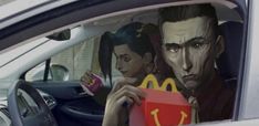 two people sitting in the back seat of a car with a mcdonald's sign