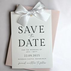 a wedding save the date card with a white bow