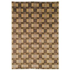 a brown and beige rug with squares on the bottom, in different sizes and colors