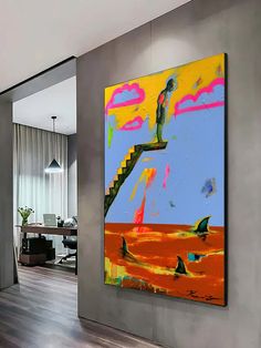 an abstract painting hangs on the wall above a wooden floor