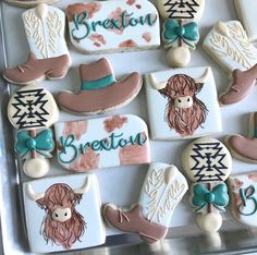 decorated cookies in the shape of cowboy hats and boots