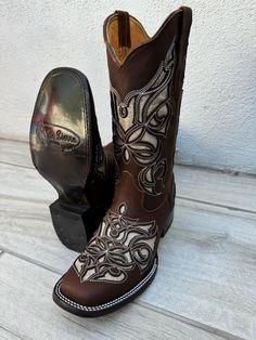 **DUE TO WIDE SQUARE TOE PLEASE ORDER HALF SIZE SMALLER** MADE IN MEXICO A true cowgirl boot, it features a genuine leather upper with fancy western embroidery. This boot utilizes an air mesh lining for excellent breathability without sacrificing quality, fit, or durability. This boots is sure to be one of your favorites, both in and out of the saddle. **DUE TO WIDE SQUARE TOE PLEASE ORDER HALF SIZE SMALLER** 1 1/2" heel height 11" shaft Western Glitter embroidery Lightweight, leather outsole Cowboy Boots In The Air, Square Toed Boots, Glitter Embroidery, Cute Cowgirl Boots, Cowboy Boots For Women, Western Embroidery, Brown Glitter, Womens Cowgirl Boots, Western Shoes