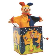 a toy clown is sitting in a box