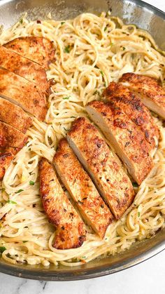 some chicken and noodles in a pan on a table