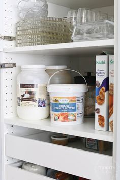 an organized pantry with cereal, milk and other items