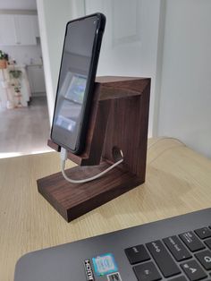 an electronic device charging on a wooden stand