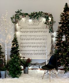 christmas trees and sheet music in front of a wall