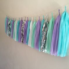 there are many different colored streamers hanging on the wall